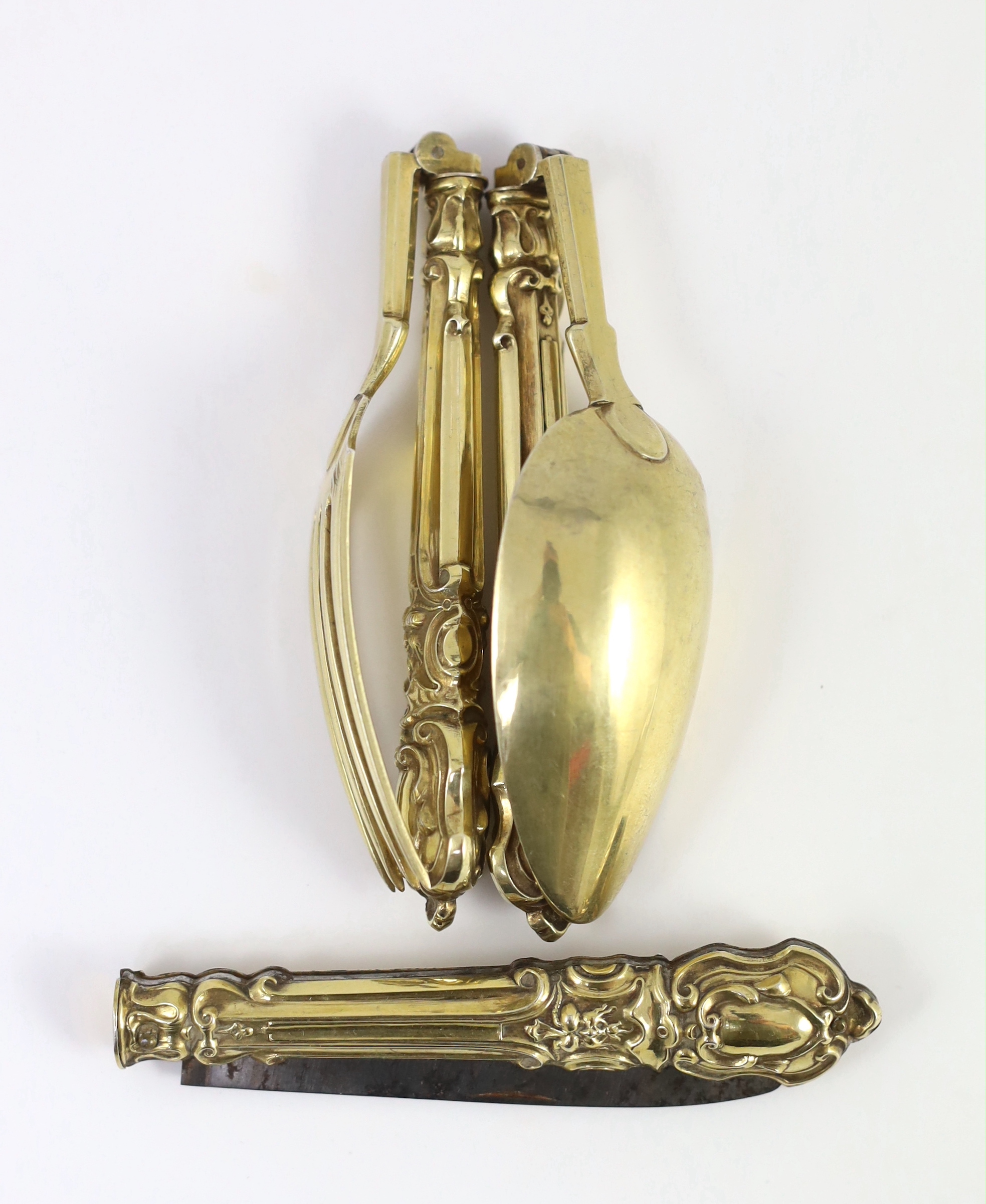 A 19th century French silver gilt three piece folding cutlery set with mascaroon green man decoration